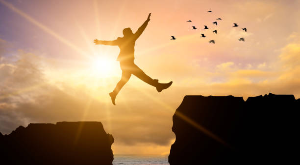 istock Business people are jumping across the abyss 1189102753