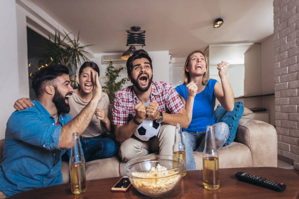 istock Friends watching sport on tv 1189103392