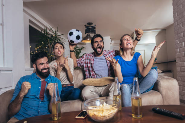 istock Friends watching sport on tv 1189104778