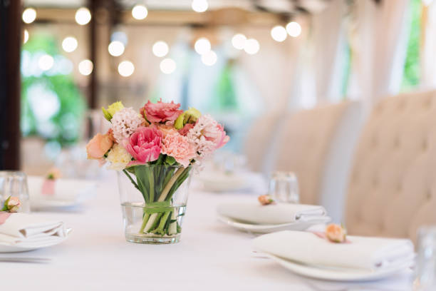 istock Flower table decorations for holidays and wedding dinner. Table set for holiday, event, party or wedding reception in outdoor restaurant. 1189104874