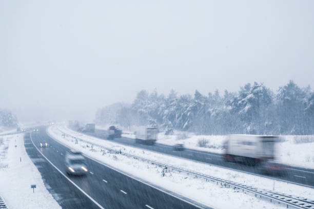 istock Traffic on a highway during a snow blizzard in winter 1189104886