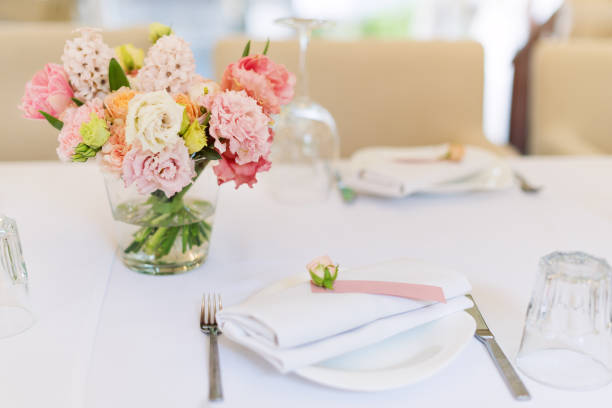 istock Flower table decorations for holidays and wedding dinner. Table set for holiday, event, party or wedding reception in outdoor restaurant. 1189104889