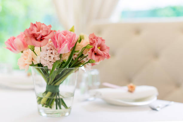 Flower table decorations for holidays and wedding dinner. Table set for holiday, event, party or wedding reception in outdoor restaurant