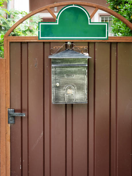 istock Patina mailbox hanging on a brown iron door 1189107324