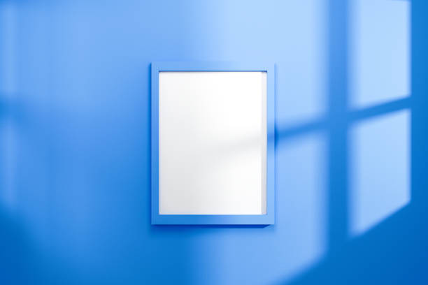 istock Empty frame on vivid blue wall background with natural light of window. Display of showing exhibition. Realistic 3D render. 1189107609