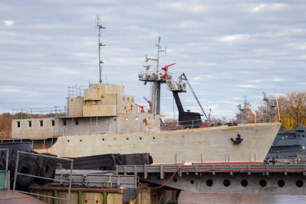 istock Old shabby russian minesweeper in harbour. 1189107816