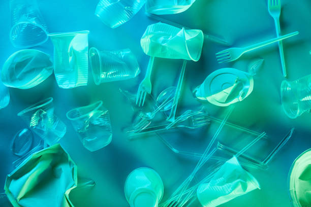 istock top view of crumpled plastic cups, straws and forks in blue light 1189109181