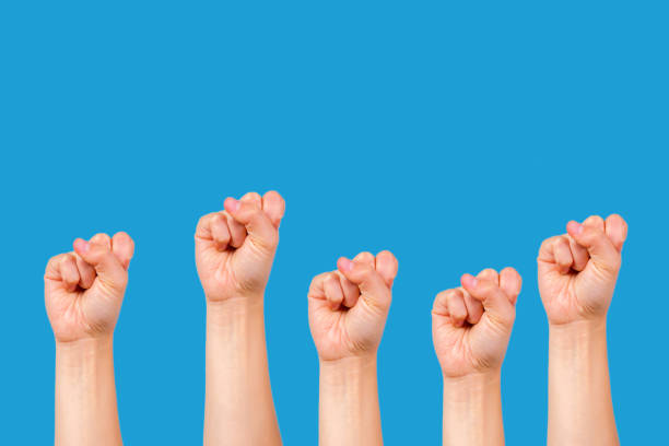 istock many fists on blue background. 1189111159