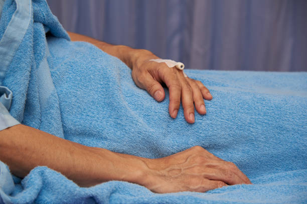 istock Side view of patient hand with needle 1189111500