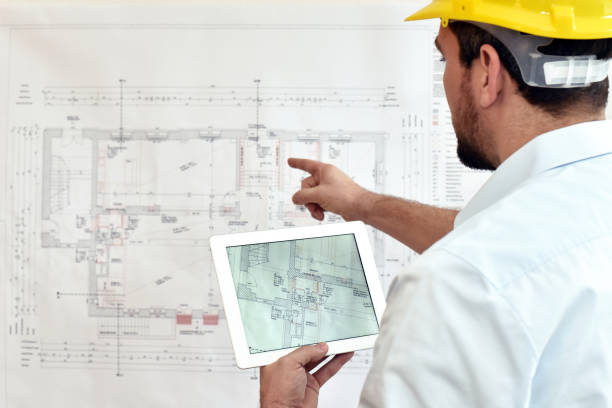 istock ArchitectPlanning Construction of a house on the Boaerd with the technical drawing - floor plan 1189112214