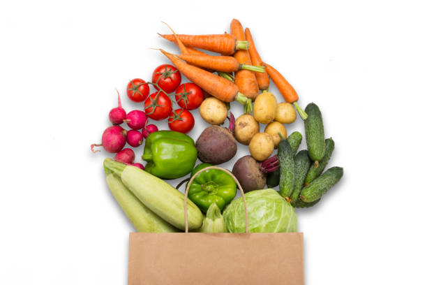 istock Paper shopping bag and fresh organic vegetables on a white backg 1189112232