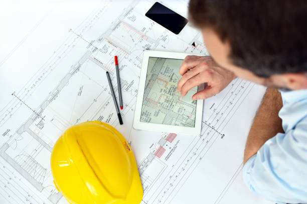 istock ArchitectPlanning Construction of a house on the Boaerd with the technical drawing - floor plan 1189112770
