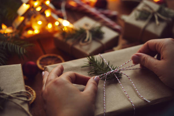 istock Woman wrapping Christmas gift in paper on table 1189112856