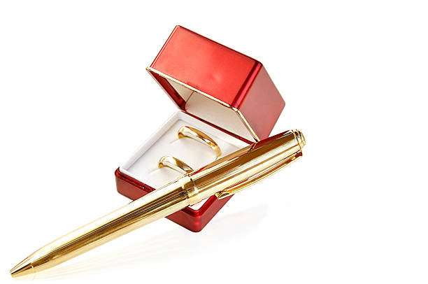 istock Wedding rings and golden pen. 118911301