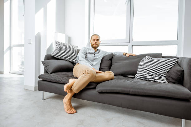 istock Man on the couch at home 1189115878