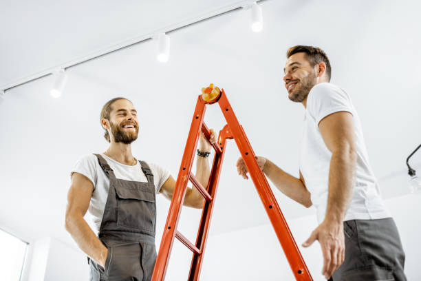 istock Two workmen talking during some repairment at home 1189116131