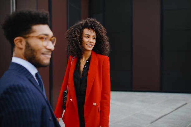 istock Smiling business couple chatting on their way to work 1189116835