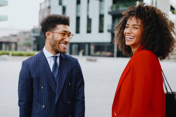 istock Smiling business couple chatting on their way to work 1189116845