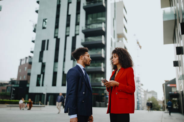 istock Business people using mobile phone at city 1189116857
