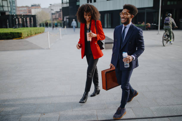 istock Coworkers chatting while walking to their place of work 1189116922