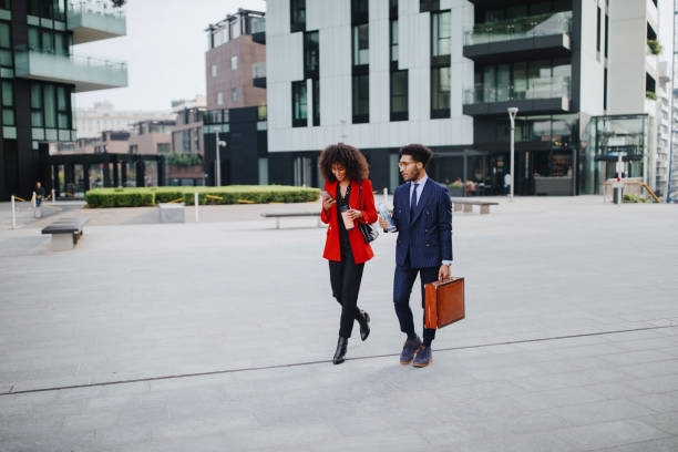 istock Coworkers chatting while walking to their place of work 1189117143
