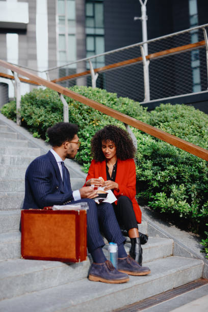 istock Coworkers having lunch break outdoors 1189117753