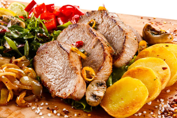 Roast steaks with fried potatoes and vegetable salad