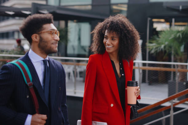 istock Smiling business couple chatting on their way to work 1189117914