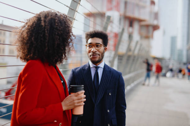 istock Smiling business couple chatting on their way to work 1189117930