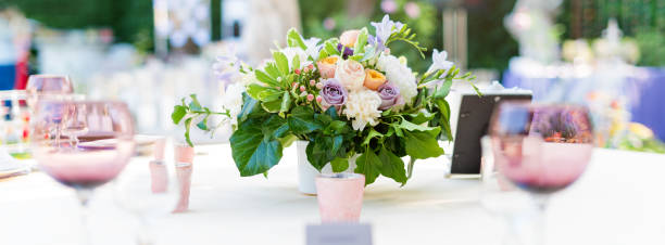 istock Flower table decorations for holidays and wedding dinner. Table set for holiday, event, party or wedding reception in outdoor restaurant. 1189119449