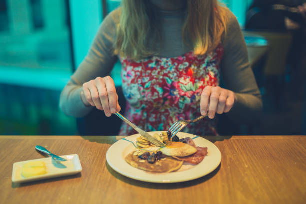 istock Young woman having breakfast in hotel 1189119603