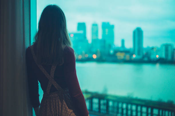 istock Woman looking at skyscrapers 1189119764