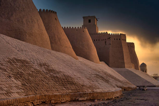 Sunset at the ancient city walls of Khiva, silk road, Uzbekistan Last daylight at the city walls oft he ancient city of Khiva, one of the most famous places at the historic silk road.

Khiva was also known in the past as Kheeva, Khorasam, Khoresm, Khwarezm, Khwarizm, Khwarazm, Chorezm. samarkand urban stock pictures, royalty-free photos & images