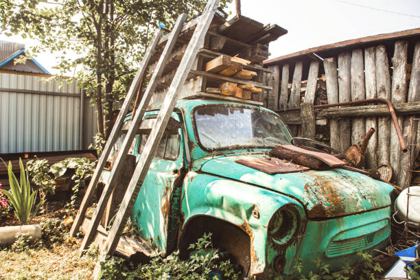 istock Old abandoned retro car among grass and old boards 1189120621