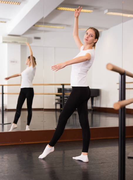 istock Woman warming up in dance hall 1189122171
