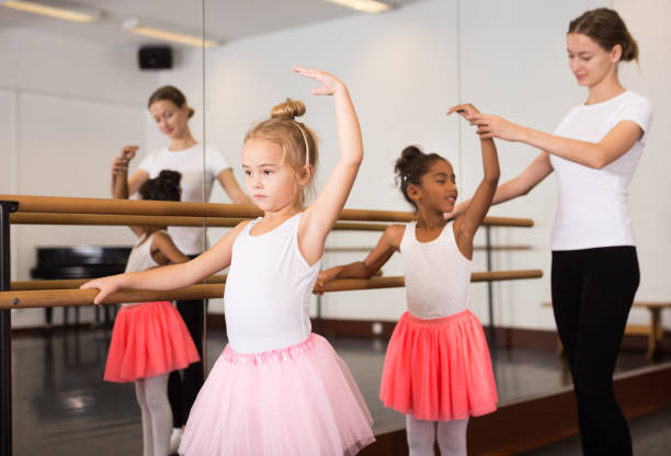 istock Ballet trainer teaching two little girls 1189122567