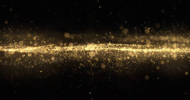 istock Gold glitter particles wave, light bokeh effect, golden shimmer sparks overlay. Gold glow and shimmering sparkles shine, abstract magic snow bright light wave motion on black background 1189123897