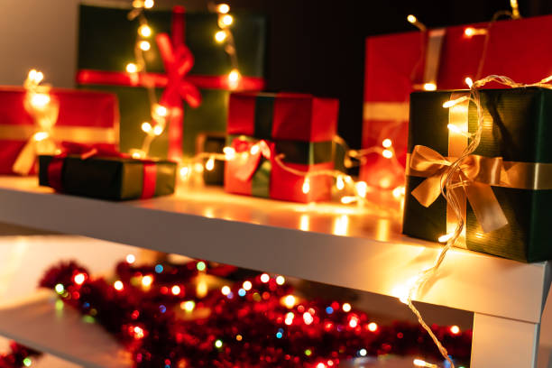 istock Christmas present in front Christmas lights  and presents in background 1189126635