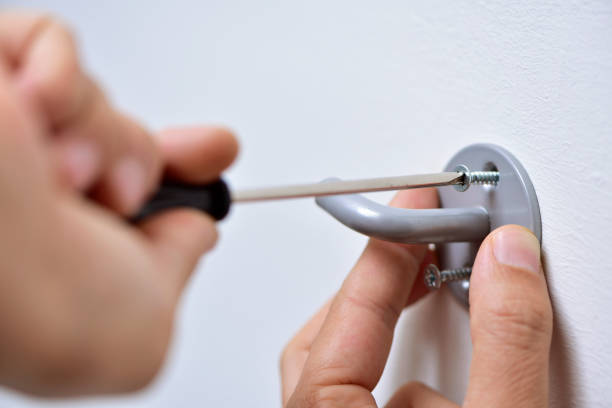 istock young man screwing a hook in the wall 1189127377
