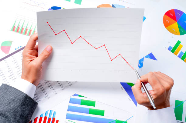istock businessman observing a chart with a downward trend 1189127935