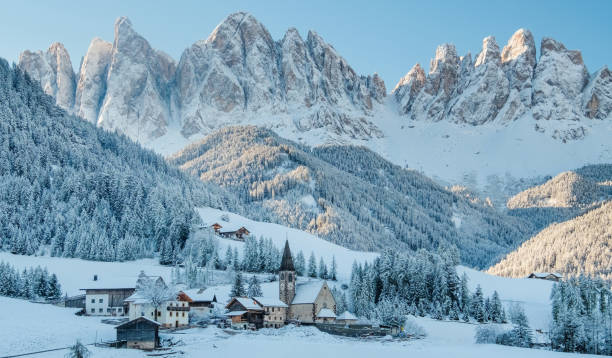 The small village in Dolomites mountains in winter. The small village Val di Funes covered in snow, with Dolomites mountains, South Tyrol, Italy. dolomite photos stock pictures, royalty-free photos & images