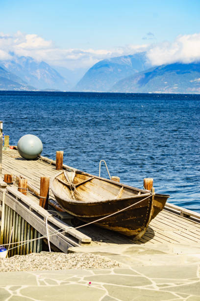 istock Old boat on pier, norway fjord 1189128150
