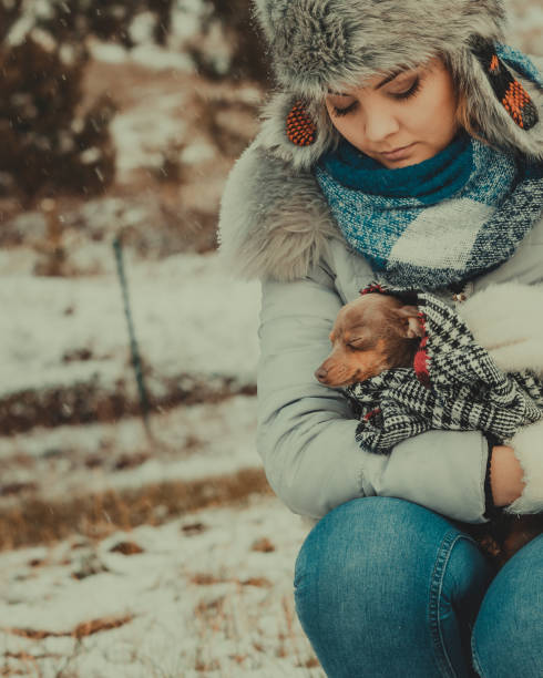 istock Sad girl hug warming her dog in cold day 1189128377