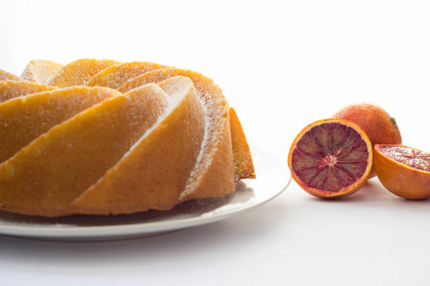 Delicious cake with blood oranges with icing sugar. White background. Food concept