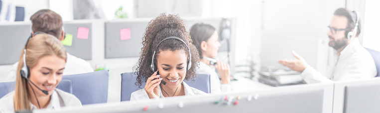 Smiling female call center representative wearing headset