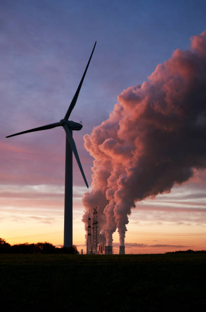 istock Wind turbine and coal fired power plant 1189129650