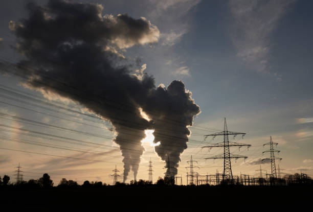 Electricity pylons and two coal fired power plants with pollution