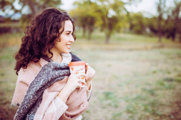istock Happy smiling young woman in autumn day 1189129919