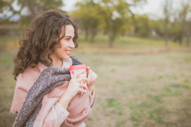 istock Woman drinking coffee in the park 1189129968