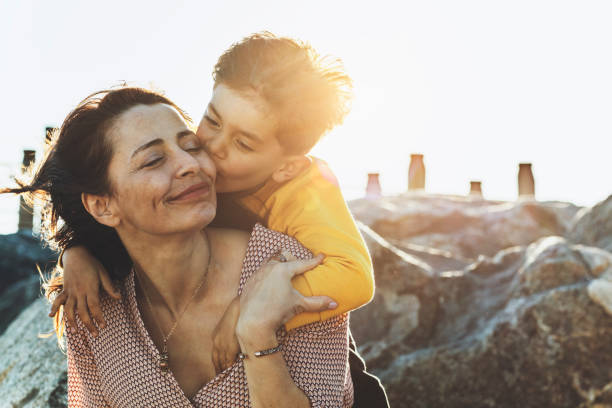 Happy mother's day! Mother hugging her child.